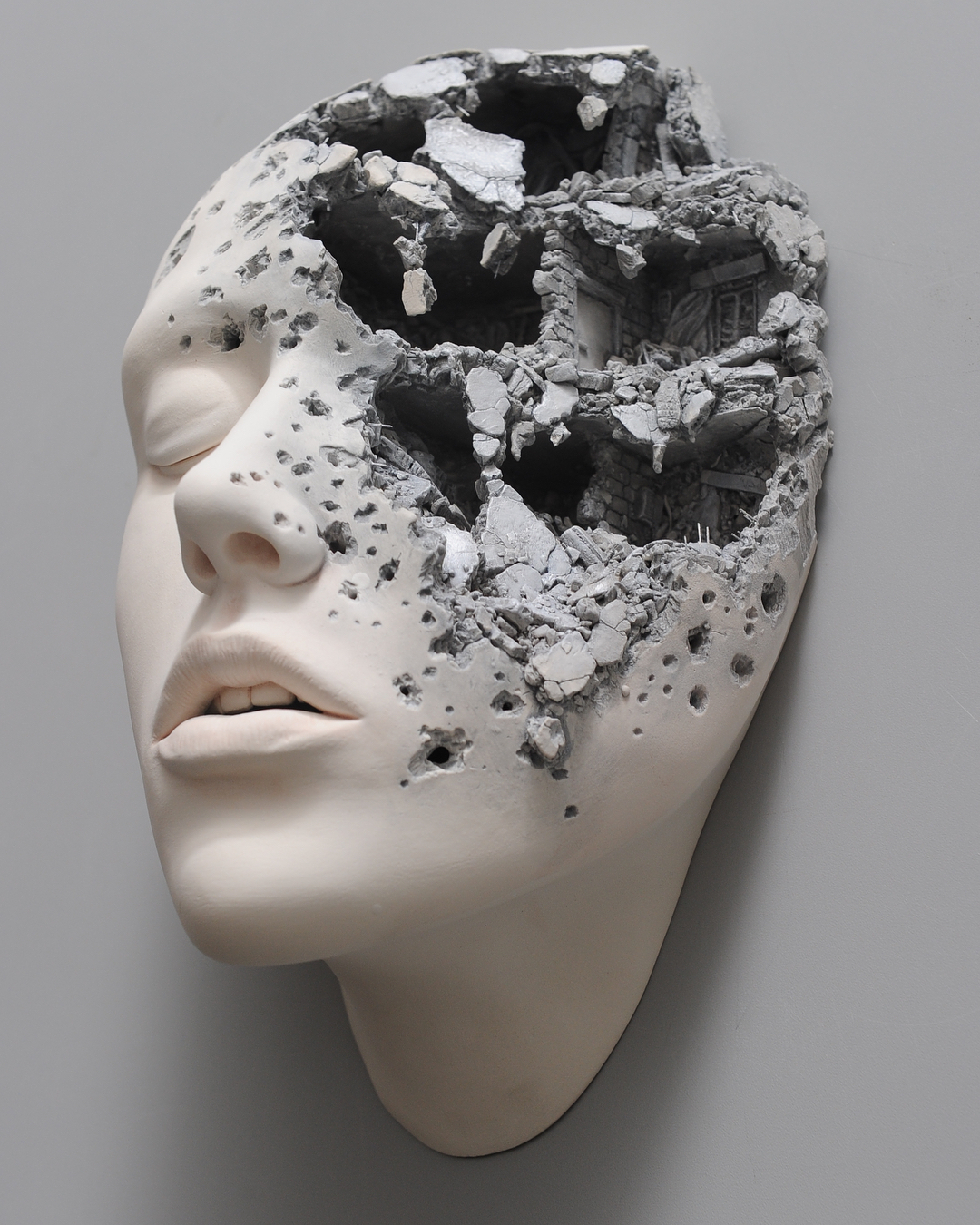 destroyed human face sculpture