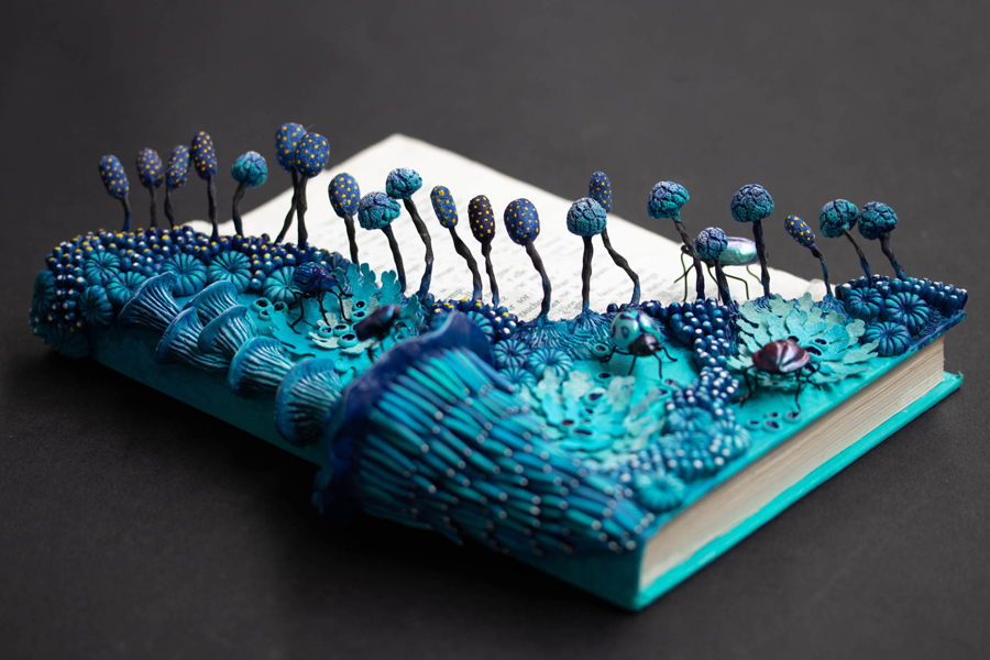 ecosystems of fungi and coral inhabit vintage books in Stéphanie Kilgast’s intricate sculptures