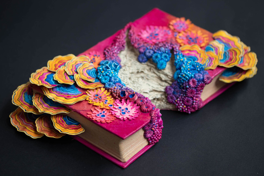 ecosystems of fungi and coral inhabit vintage books in Stéphanie Kilgast’s intricate sculptures